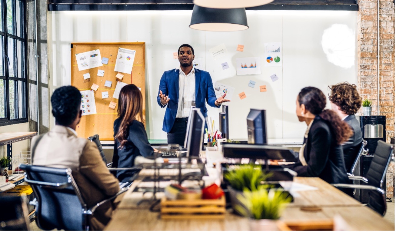 Man speaking to coworkers