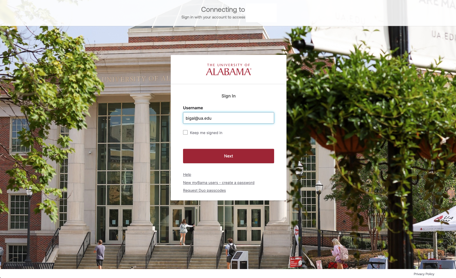 the new login screen for myBama, and ultimately every UA application and webpage. It displays a background of the UA Student Center with a white box centered on the page with a place to put username, keep me signed in, and next. This page also has help, create a password, and request Duo passcodes buttons.